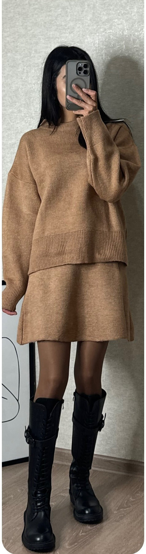 Woman in matching knitted jumper and mini skirt
