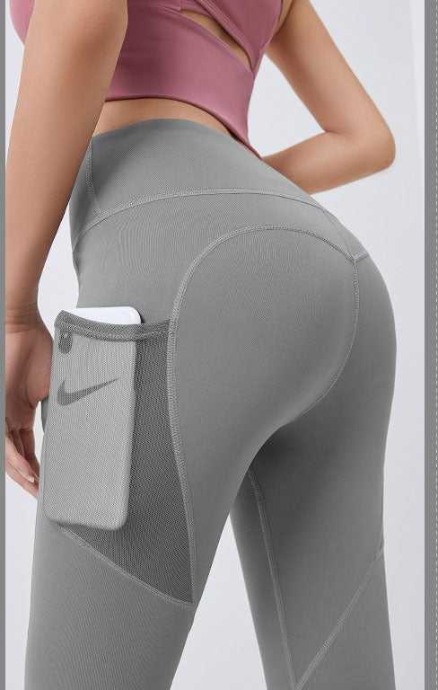 Woman wearing high-waist leggings with phone pocket